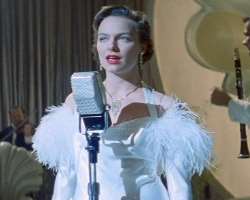 The actress appeared as a nightclub singer in American period superhero film The Rocketeer (1991), she sang the track 